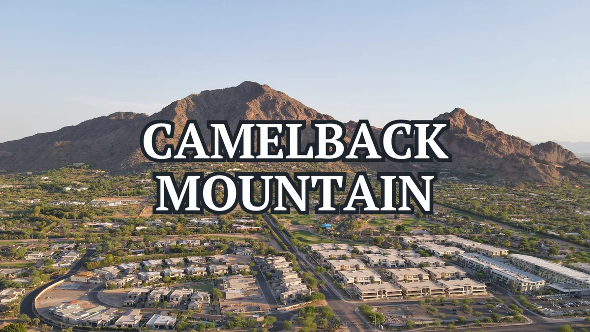 A panoramic view of Camelback Mountain with surrounding residential areas and green spaces. The natural beauty of the mountain dominates the scene, capturing the iconic Arizona backdrop visible from the backyard.