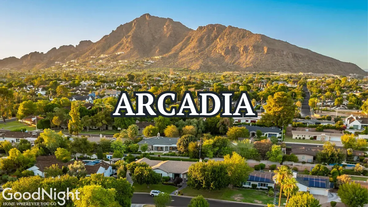 A peaceful scene featuring mountains, suburban homes, and lush greenery. The image showcases the inviting landscape and the proximity of natural attractions, with vibrant colors and a relaxed mood.