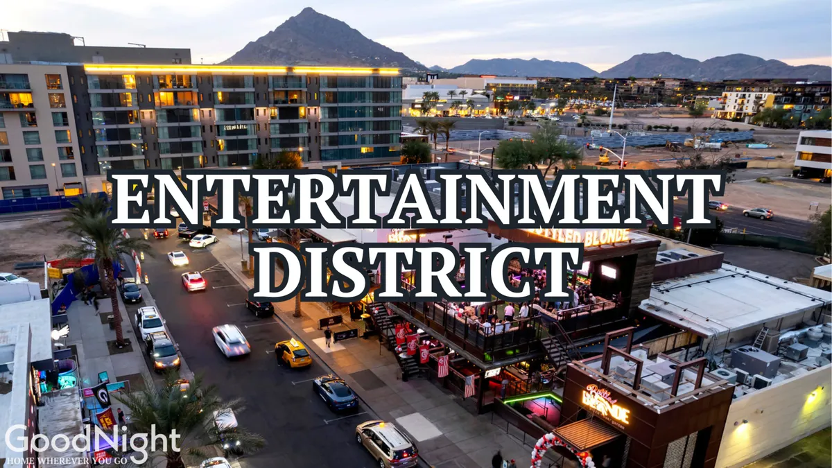 A bustling Scottsdale streetscape featuring a lively entertainment venue with a mountain backdrop. People are seen dining and socializing, with vibrant lighting and festive energy that captures the essence of Scottsdale’s nightlife and dining scene.